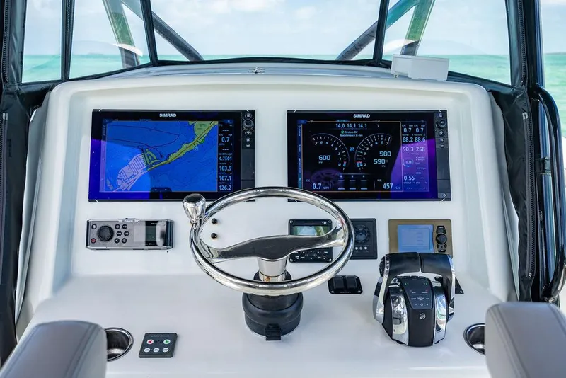 Slide: The Image of 2015 Yellowfin CC boat dashboard with navigation screens and controls. - 8