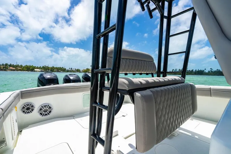 Slide: The Image of 2015 Yellowfin CC boat interior with seating, ocean view, and clear blue sky. - 9