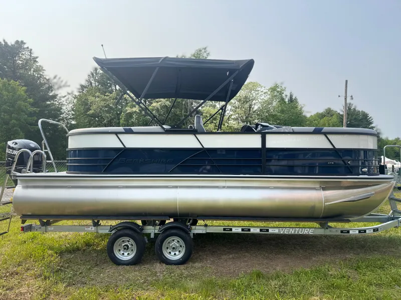 Slide: The Image of 2025 Berkshire 22RFX CTS pontoon boat on trailer, parked on grass. - 2