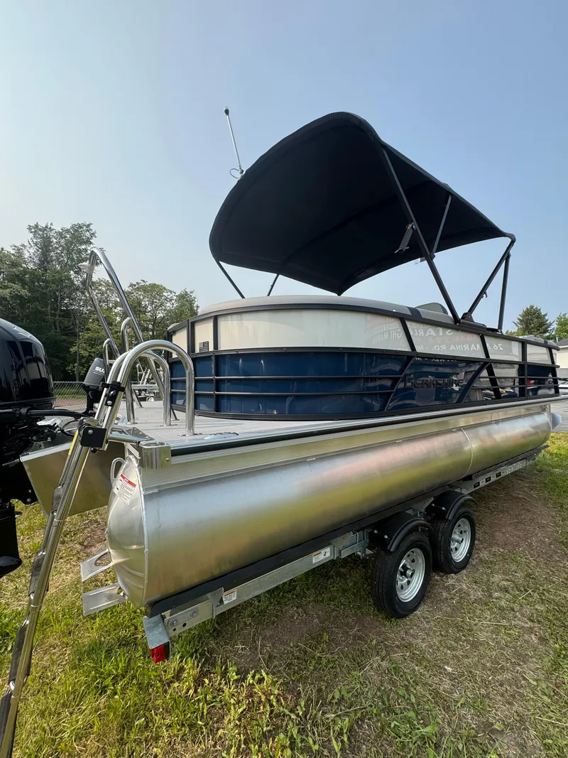 Slide: The Image of 2025 Berkshire 22RFX CTS pontoon boat with canopy on trailer, parked outdoors. - 3
