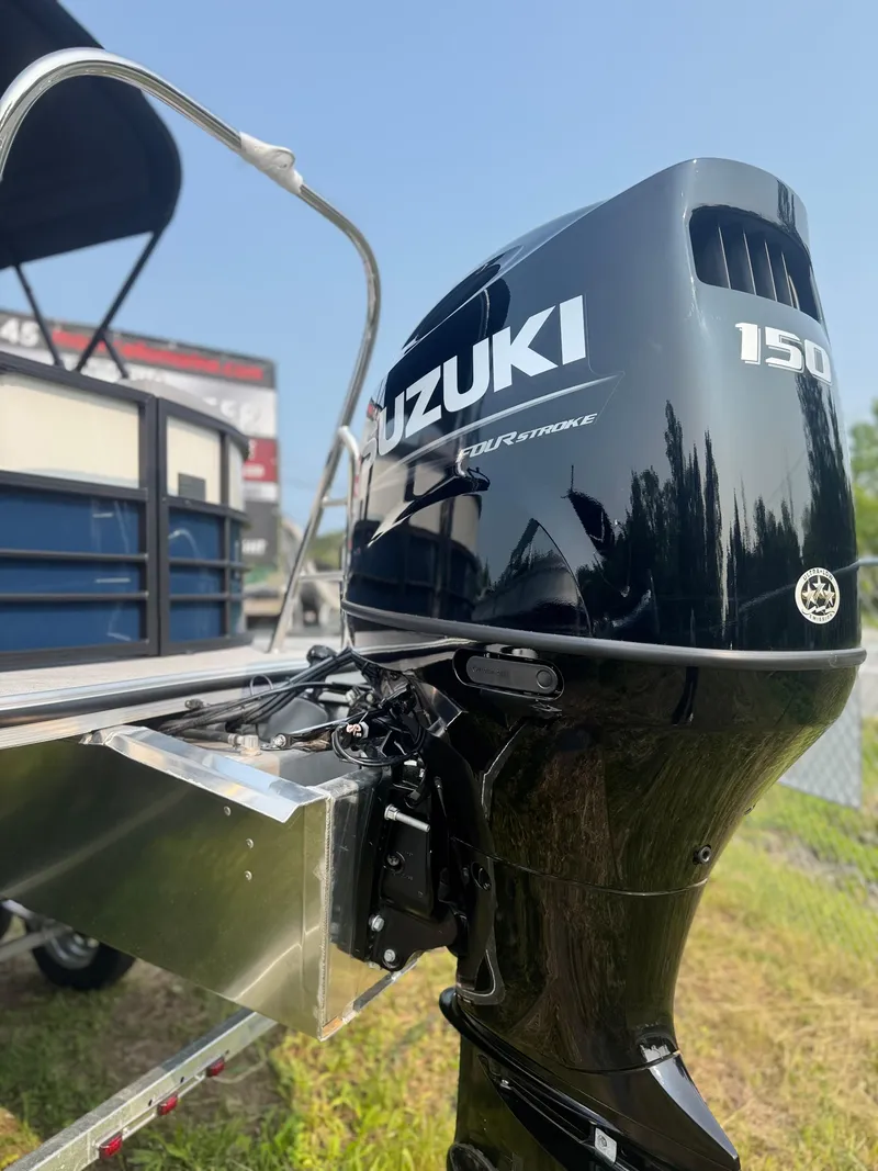 Slide: The Image of 2025 Berkshire 22RFX CTS with Suzuki 150 outboard motor, parked outdoors. - 4