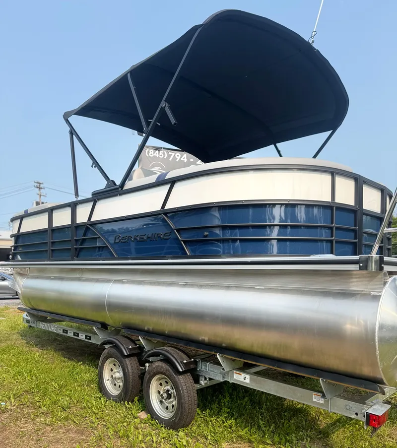 Slide: The Image of 2025 Berkshire 22RFX CTS pontoon boat on trailer with canopy, parked on grass. - 5