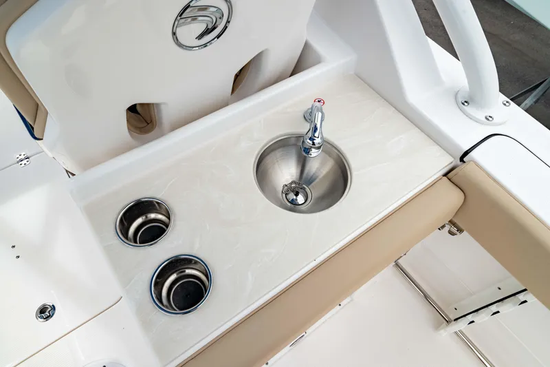 Slide: The Image of 2026 Edgewater 248 CX boat interior with sink and cup holders. - 19