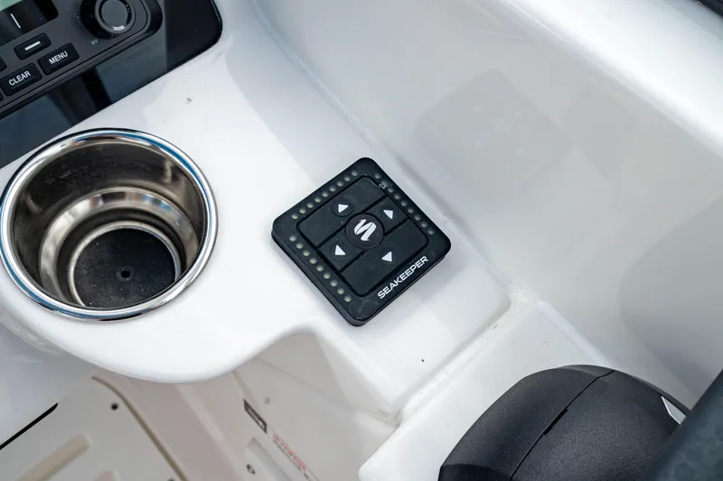 Slide: The Image of Edgewater 248 CX 2026 boat console with SeaKeeper control and cup holder. - 25