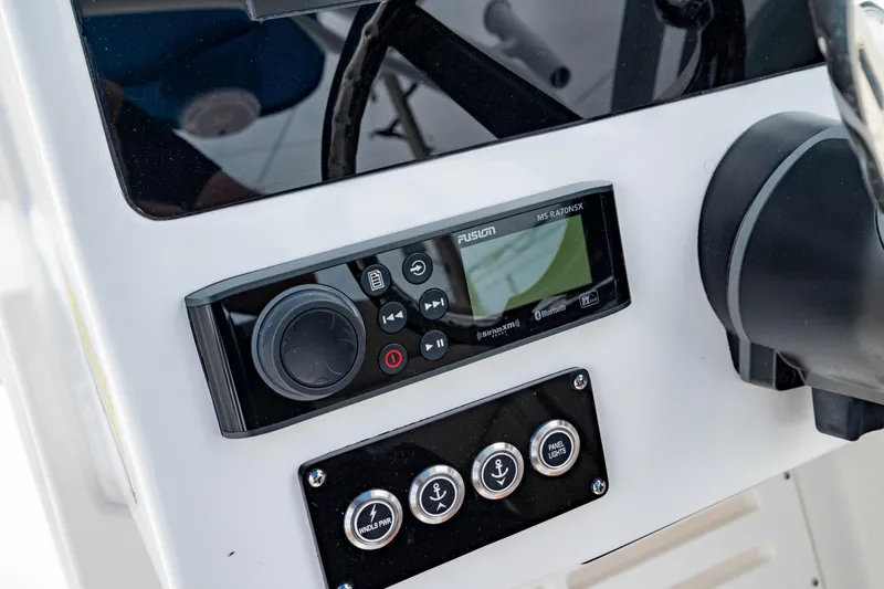 Slide: The Image of Control panel of 2026 Edgewater 248 CX boat featuring audio system and switches. - 29