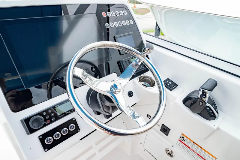 Slide: The Image of Steering console of 2026 Edgewater 248 CX boat with modern controls and display. - 31