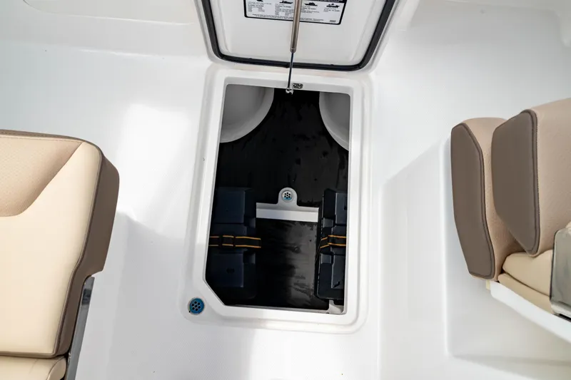 Slide: The Image of 2026 Edgewater 248 CX boat storage compartment with beige seating. - 35