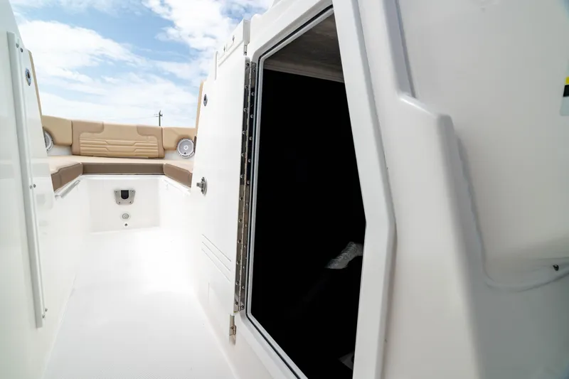 Slide: The Image of Edgewater 248 CX 2026 boat interior with open cabin door and seating area. - 36