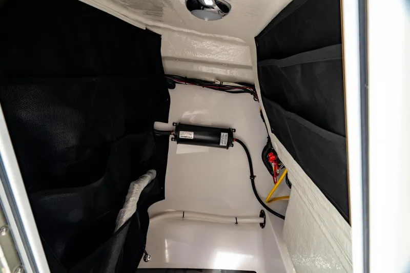 Slide: The Image of Interior view of 2026 Edgewater 248 CX boat compartment with wiring and equipment. - 37