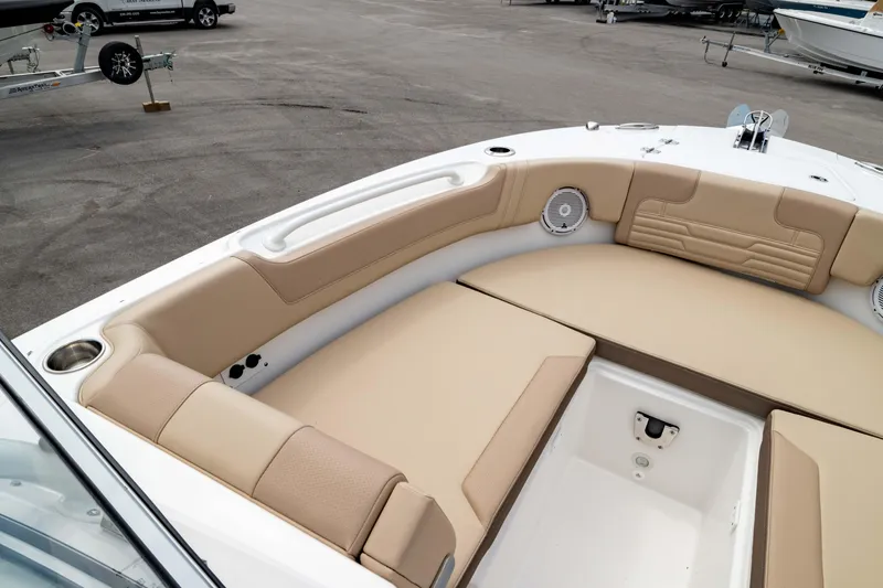 Slide: The Image of 2026 Edgewater 248 CX boat interior with beige seating and storage compartment. - 38