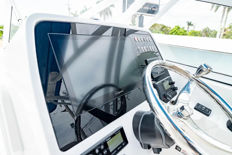 Slide: The Image of 2026 Edgewater 248 CX boat dashboard with steering wheel and modern navigation display. - 4