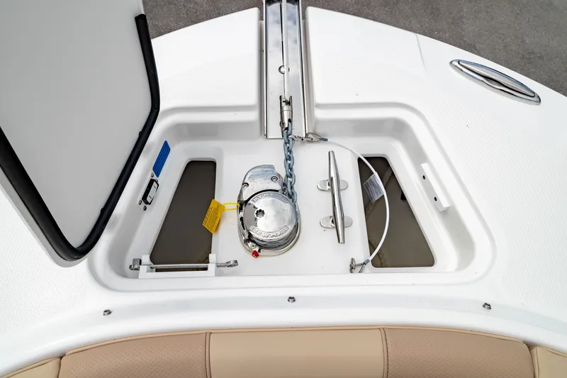 Slide: The Image of Anchor compartment of 2026 Edgewater 248 CX boat, featuring storage and chain mechanism. - 41