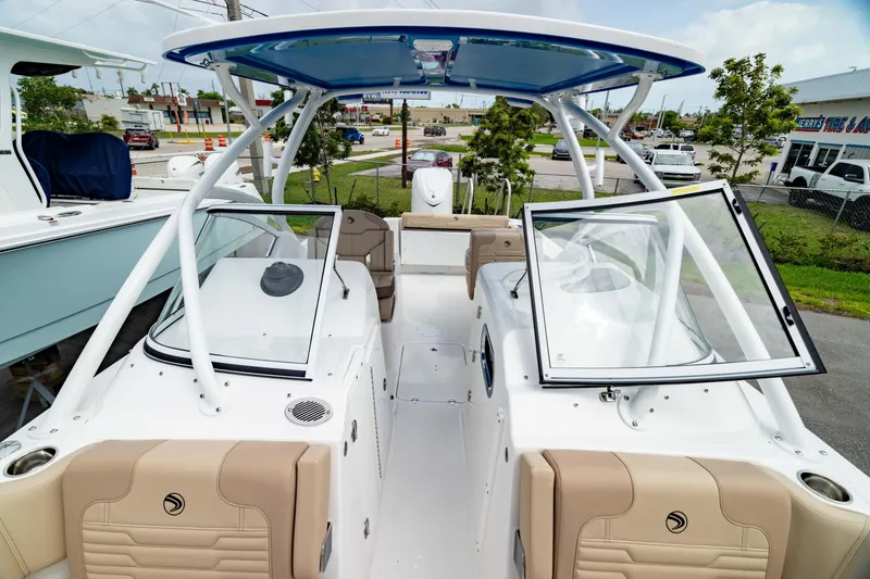 Slide: The Image of 2026 Edgewater 248 CX boat with open cockpit and seating, displayed outdoors. - 44