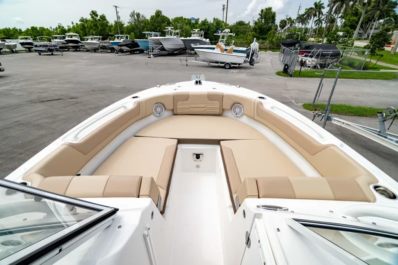 Slide: The Image of 2026 Edgewater 248 CX boat with spacious seating in a marina setting. - 5