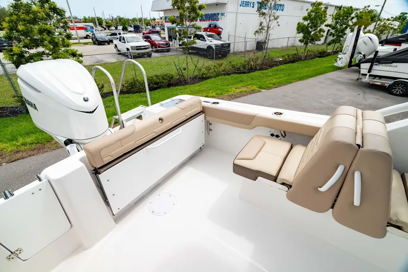 Slide: The Image of 2026 Edgewater 248 CX boat interior with beige seating and Yamaha outboard motor. - 8
