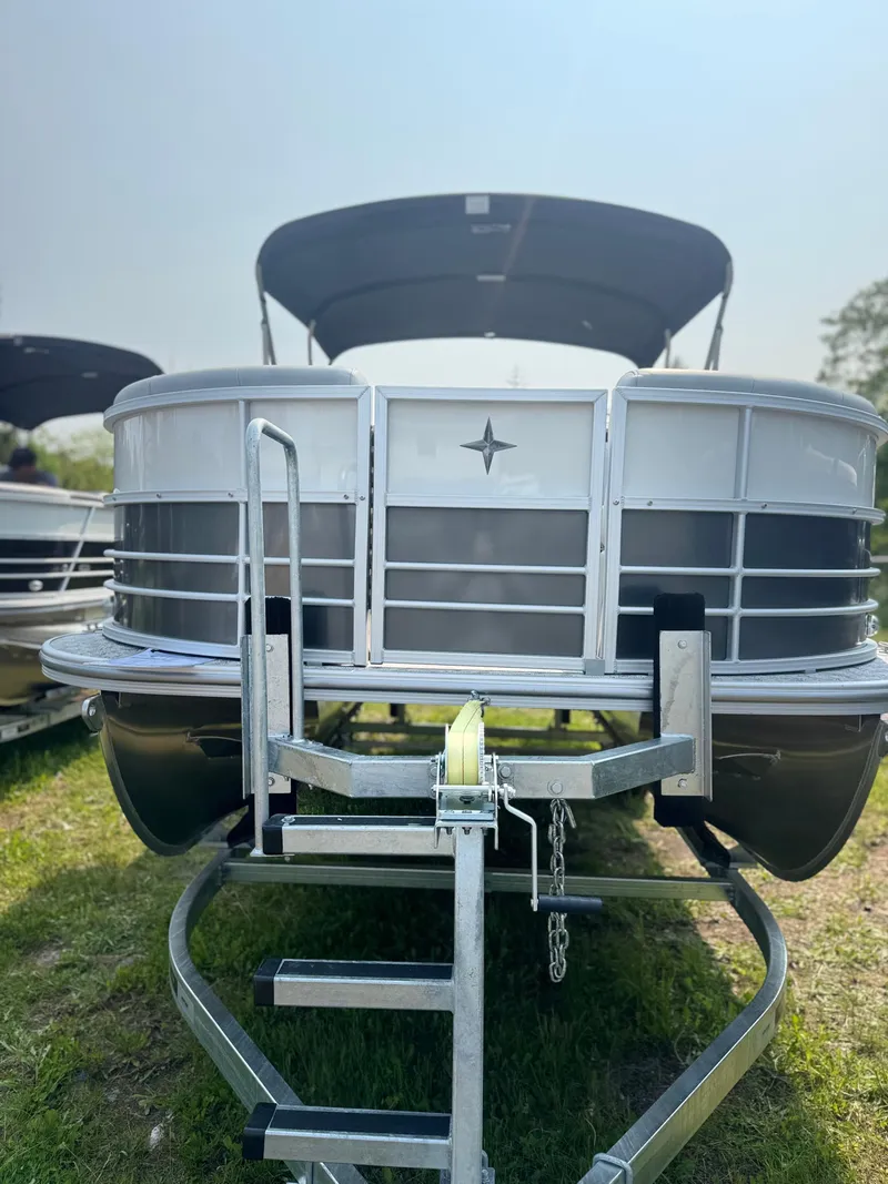 Slide: The Image of 2025 Berkshire 22RFX LE pontoon boat on trailer, front view, outdoors. - 5
