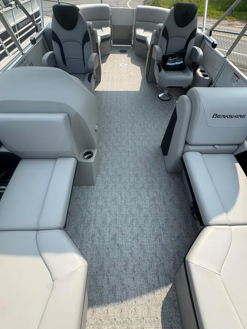 Slide: The Image of 2025 Berkshire 22RFX LE pontoon boat interior with gray seating and carpet. - 7