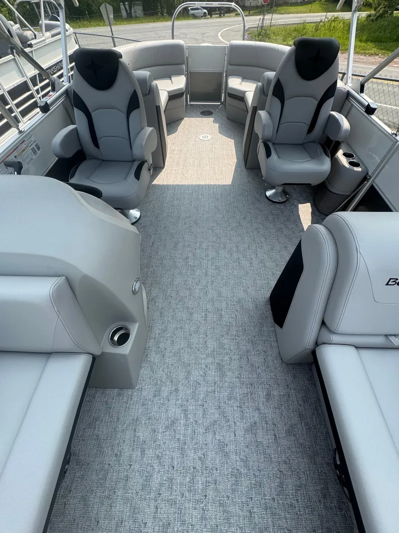 Slide: The Image of 2025 Berkshire 22RFX LE boat interior with gray seating and carpeted floor. - 8