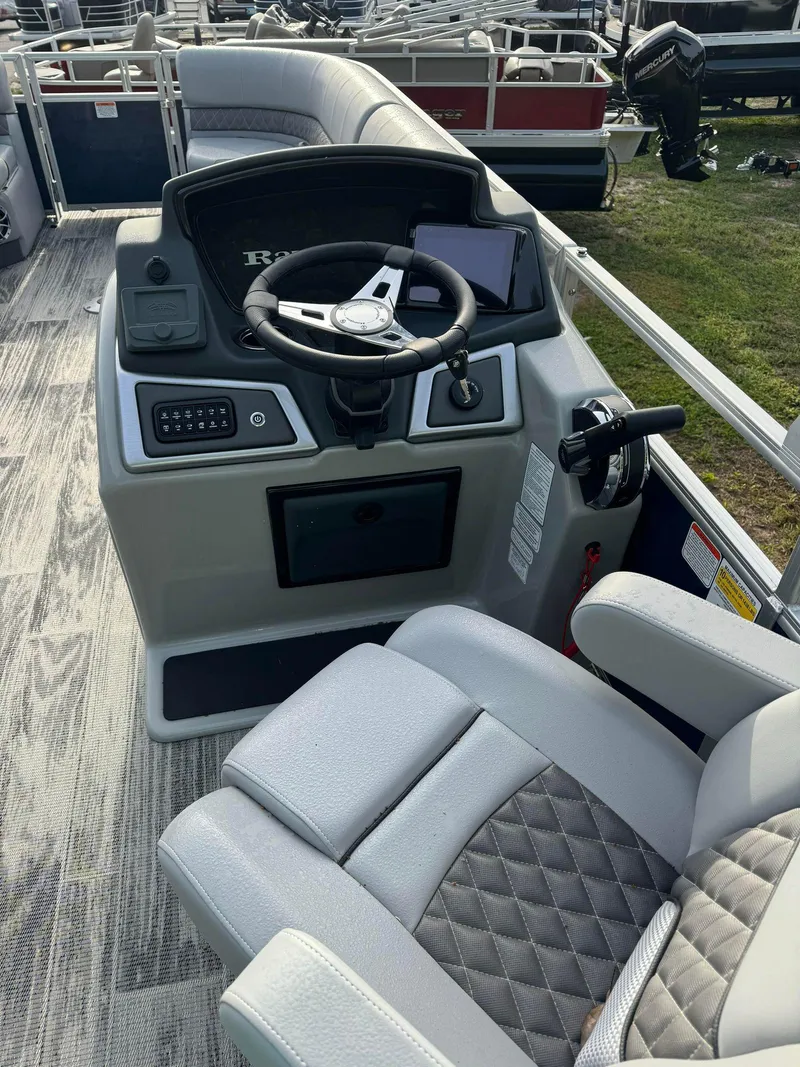 Slide: The Image of 2024 Ranger Reata 220C boat interior with steering console and seating. - 3