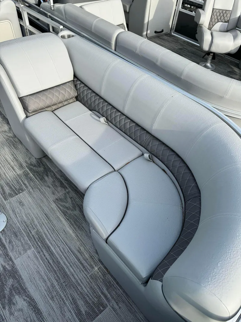 Slide: The Image of 2024 Ranger Reata 220C boat interior with plush gray seating and modern design. - 6