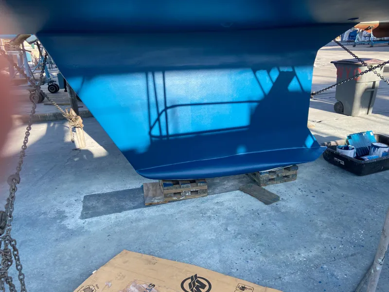 Slide: The Image of Blue hull of 2000 Hunter Passage 420 sailboat on dry dock. - 3