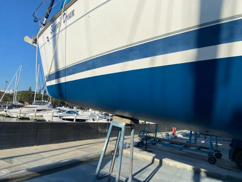 Slide: The Image of Hunter Passage 420 sailboat from 2000 on dry dock, with blue and white hull. - 4