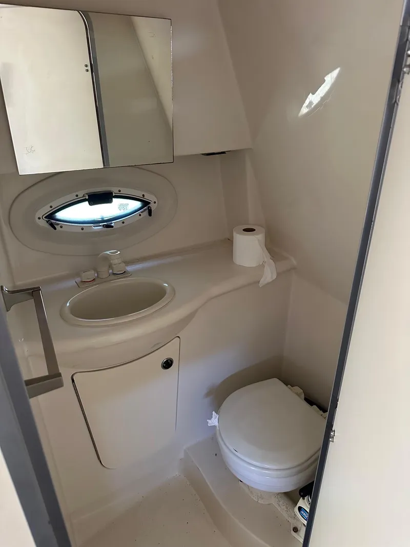 Slide: The Image of 2008 Bayliner 265 boat bathroom with sink, mirror, and toilet. - 10