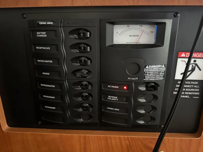 Slide: The Image of Electrical control panel of a 2008 Bayliner 265 boat, featuring various switches and voltage meter. - 12