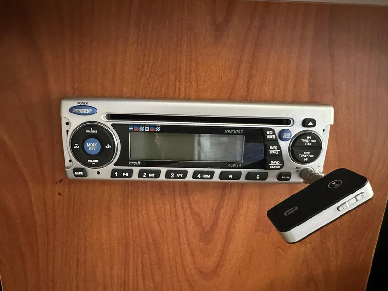 Slide: The Image of Jensen stereo system in 2008 Bayliner 265 boat, mounted on wooden panel. - 13