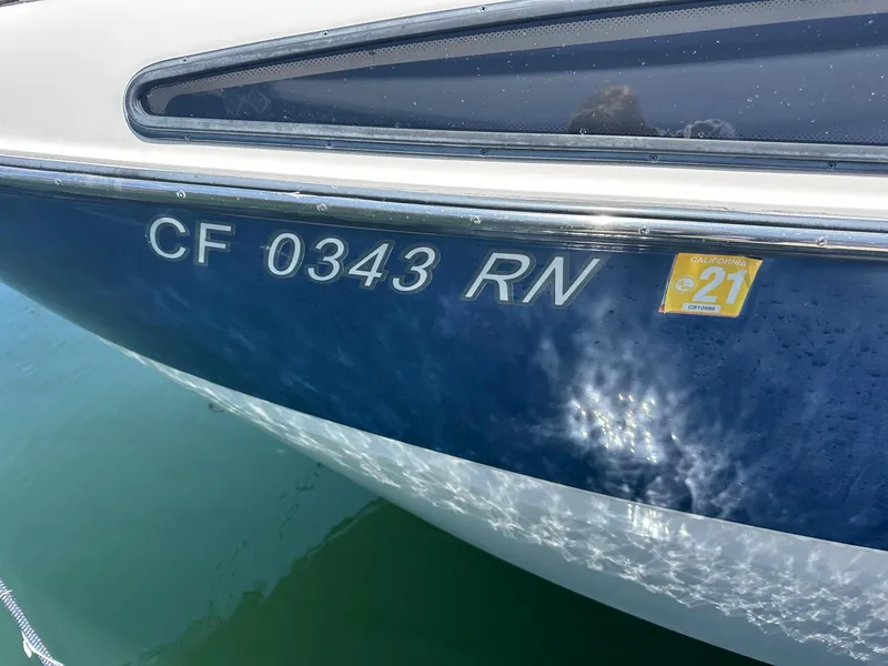Slide: The Image of 2008 Bayliner 265 boat with registration CF 0343 RN on blue hull. - 2