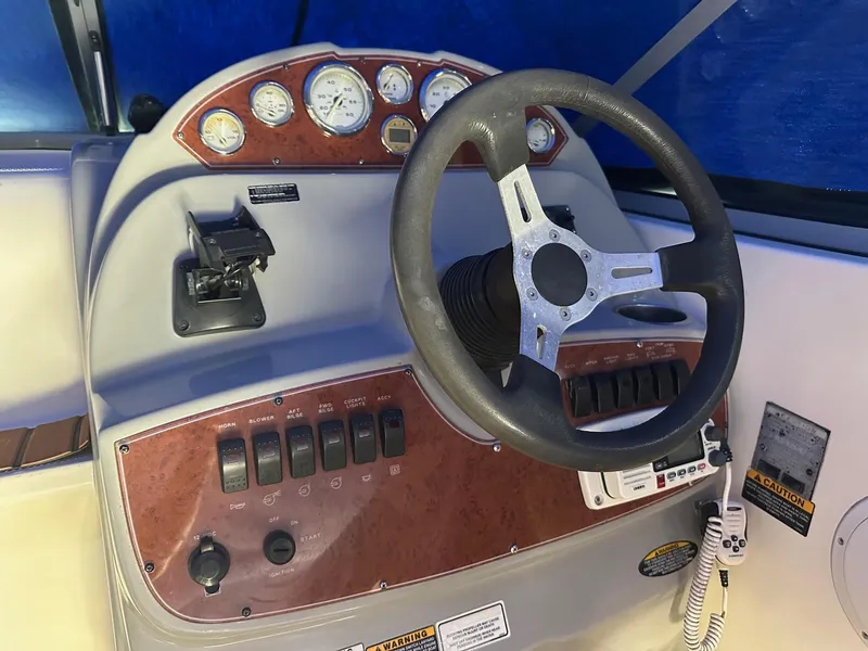 Slide: The Image of 2008 Bayliner 265 helm with steering wheel, gauges, and control panel. - 5