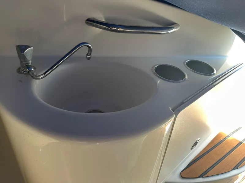 Slide: The Image of 2008 Bayliner 265 boat sink with faucet and cup holders. - 6