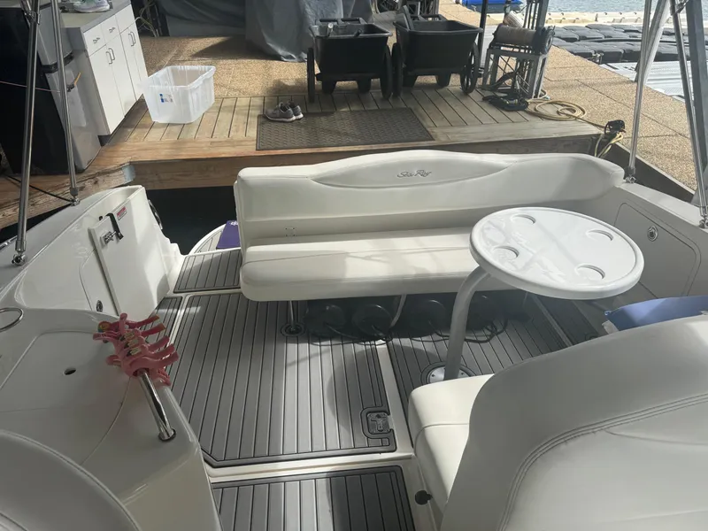 Slide: The Image of 2006 Sea Ray 280 Sundancer boat interior with seating and table, docked at marina. - 13