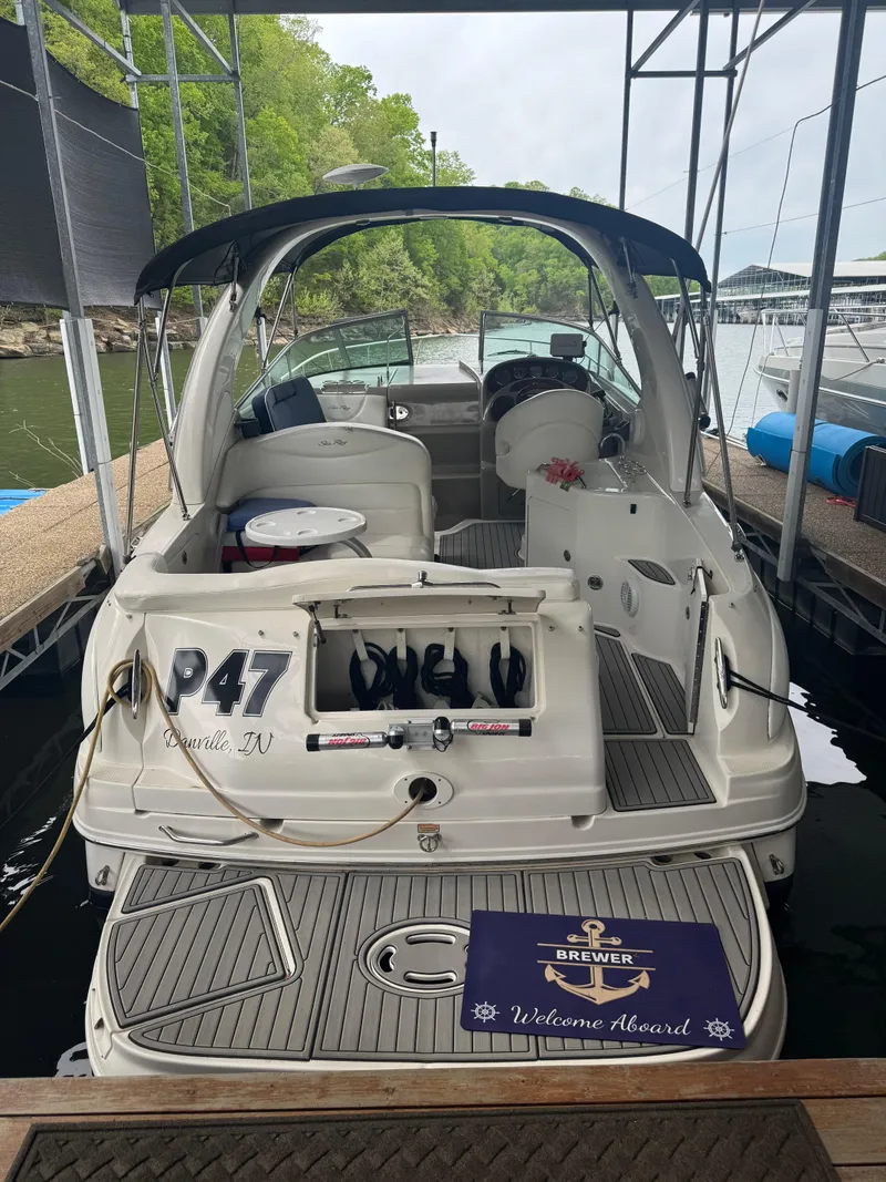 Slide: The Image of 2006 Sea Ray 280 Sundancer docked, featuring spacious deck and welcome mat. - 16