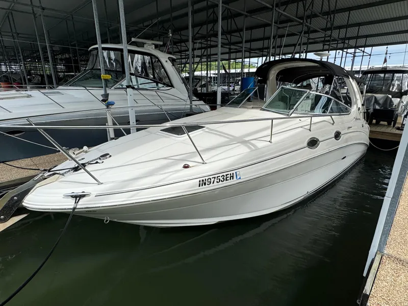 Slide: The Image of 2006 Sea Ray 280 Sundancer docked in a marina, side view. - 2