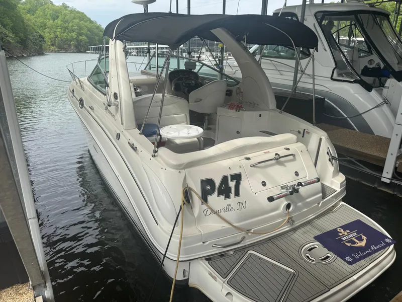 Slide: The Image of 2006 Sea Ray 280 Sundancer docked, featuring a sleek design and spacious deck area. - 3