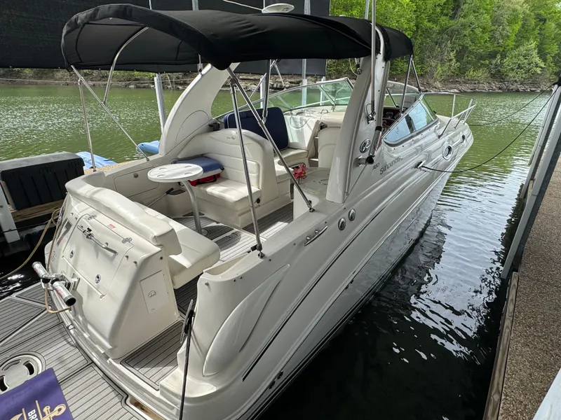 Slide: The Image of 2006 Sea Ray 280 Sundancer boat docked on calm water, featuring a sleek white design. - 4