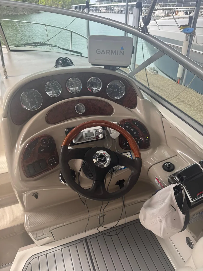 Slide: The Image of 2006 Sea Ray 280 Sundancer helm with Garmin navigation, wood accents, and modern controls. - 6