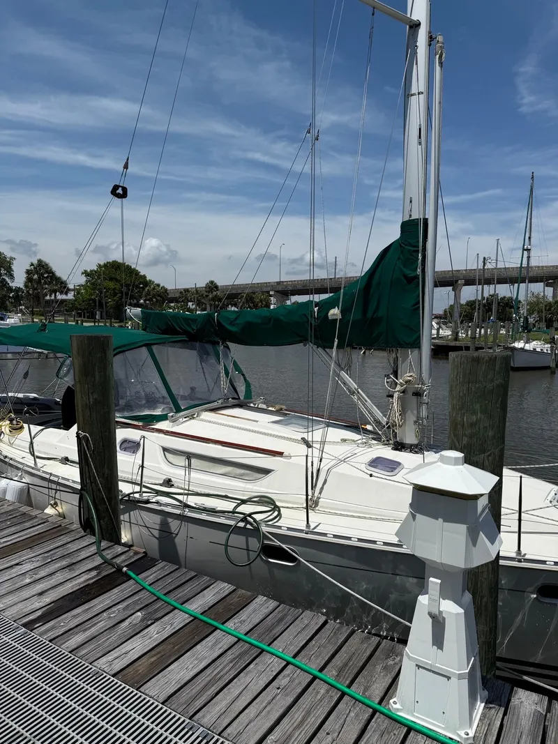 Slide: The Image of 2000 Jeanneau Sun Odyssey 36.2 sailboat docked at marina under clear blue sky. - 15
