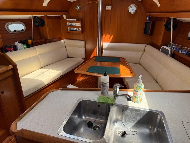 Slide: The Image of Interior of 2000 Jeanneau Sun Odyssey 36.2 sailboat with cozy seating and kitchen area. - 23
