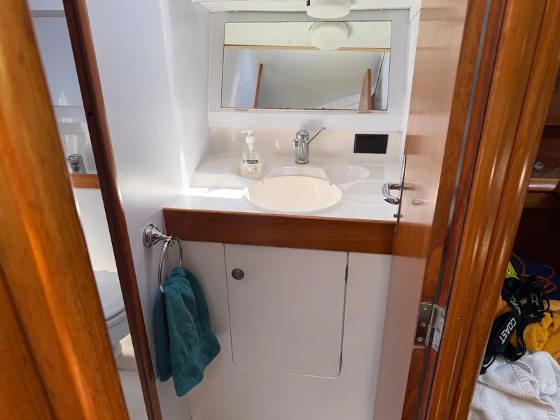 Slide: The Image of Bathroom interior of 2000 Jeanneau Sun Odyssey 36.2 yacht with sink and mirror. - 24