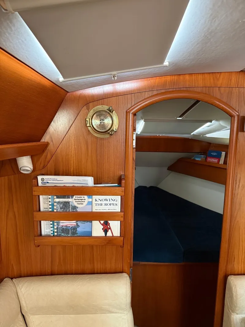 Slide: The Image of Interior of 2000 Jeanneau Sun Odyssey 36.2 sailboat with cozy cabin and bookshelf. - 25