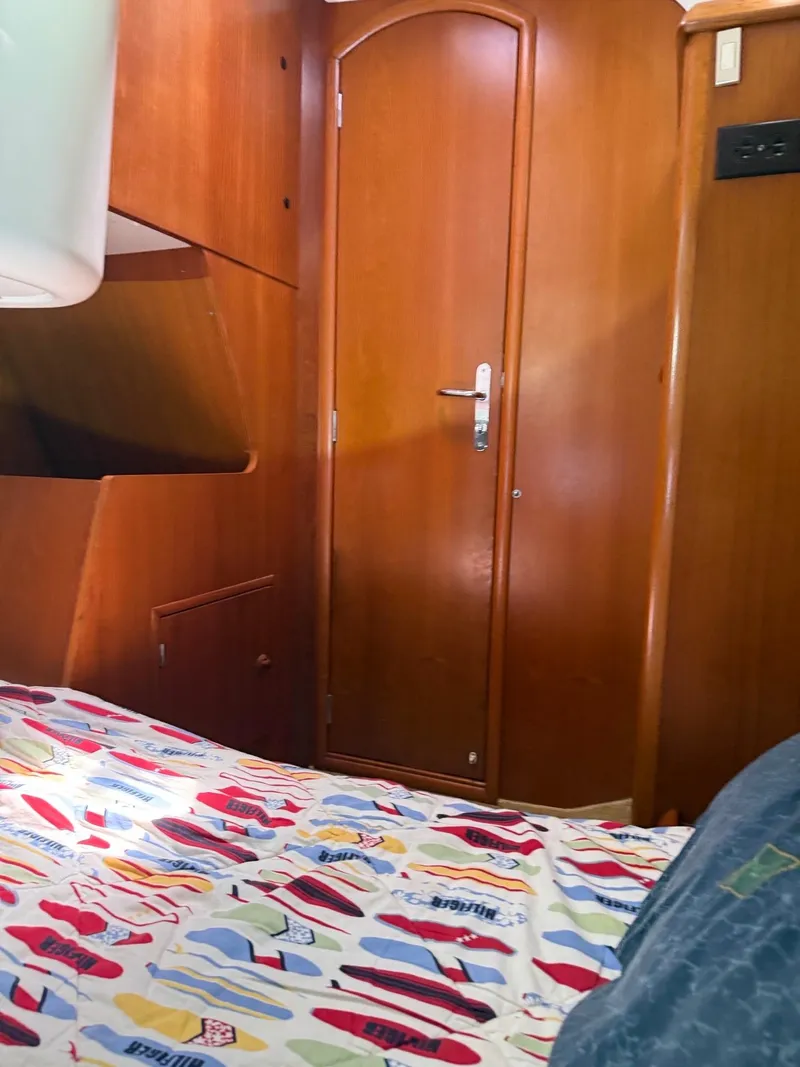Slide: The Image of Interior cabin of 2000 Jeanneau Sun Odyssey 36.2 sailboat with colorful bedding. - 27