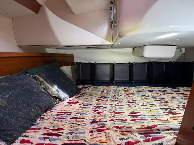 Slide: The Image of Cozy cabin interior of 2000 Jeanneau Sun Odyssey 36.2 sailboat with colorful bedding. - 29