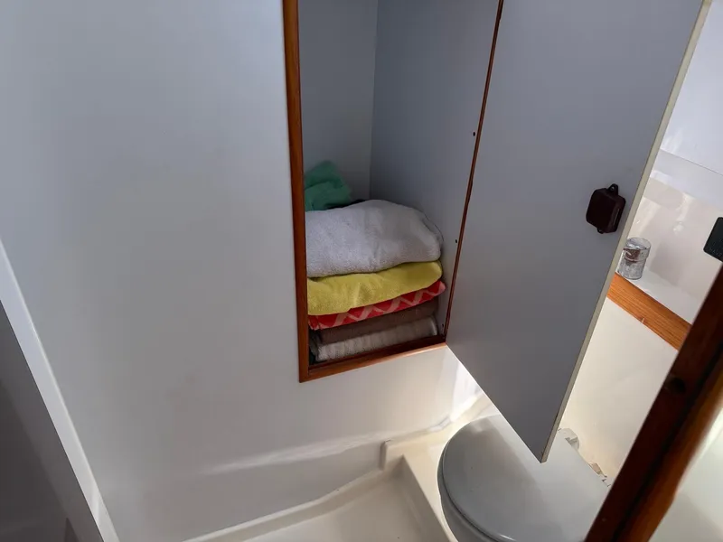 Slide: The Image of Cabin bathroom storage on 2000 Jeanneau Sun Odyssey 36.2 sailboat with towels. - 30