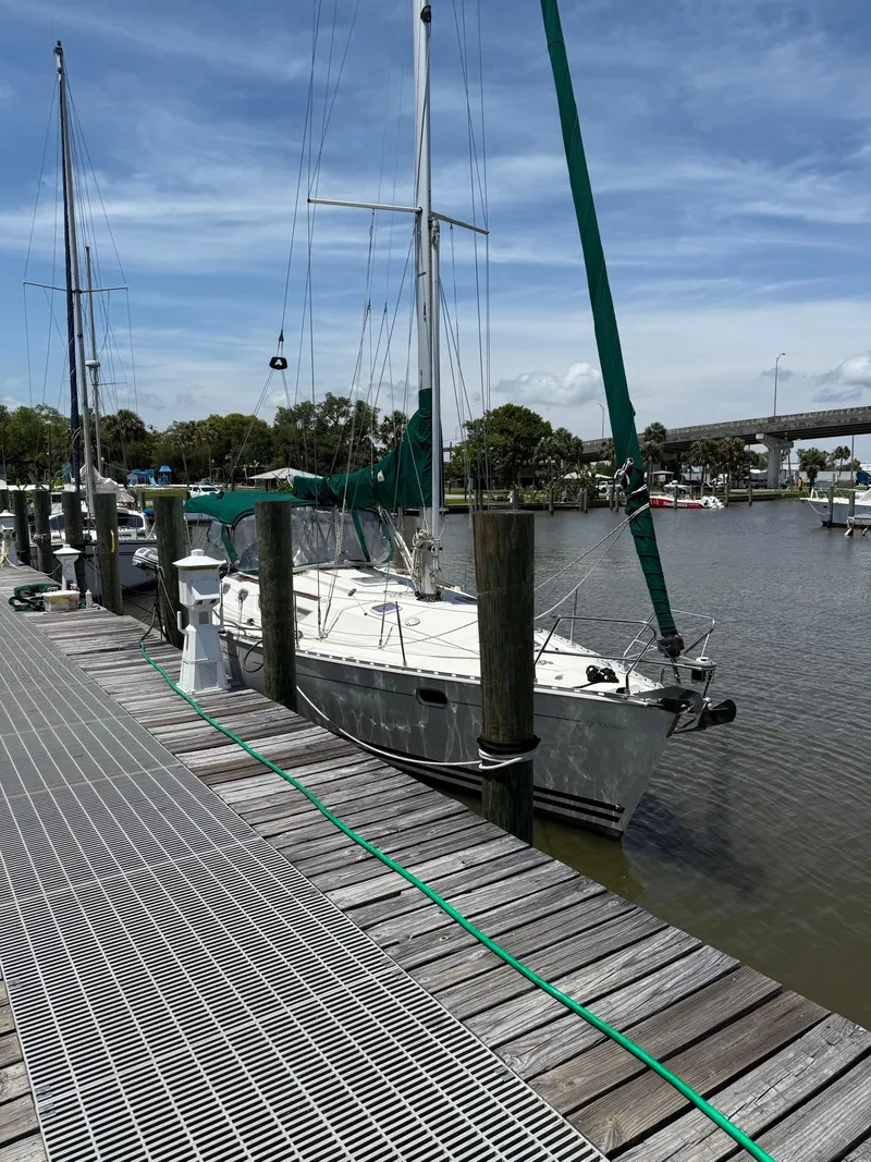 Slide: The Image of 2000 Jeanneau Sun Odyssey 36.2 sailboat docked at a marina under a clear sky. - 4