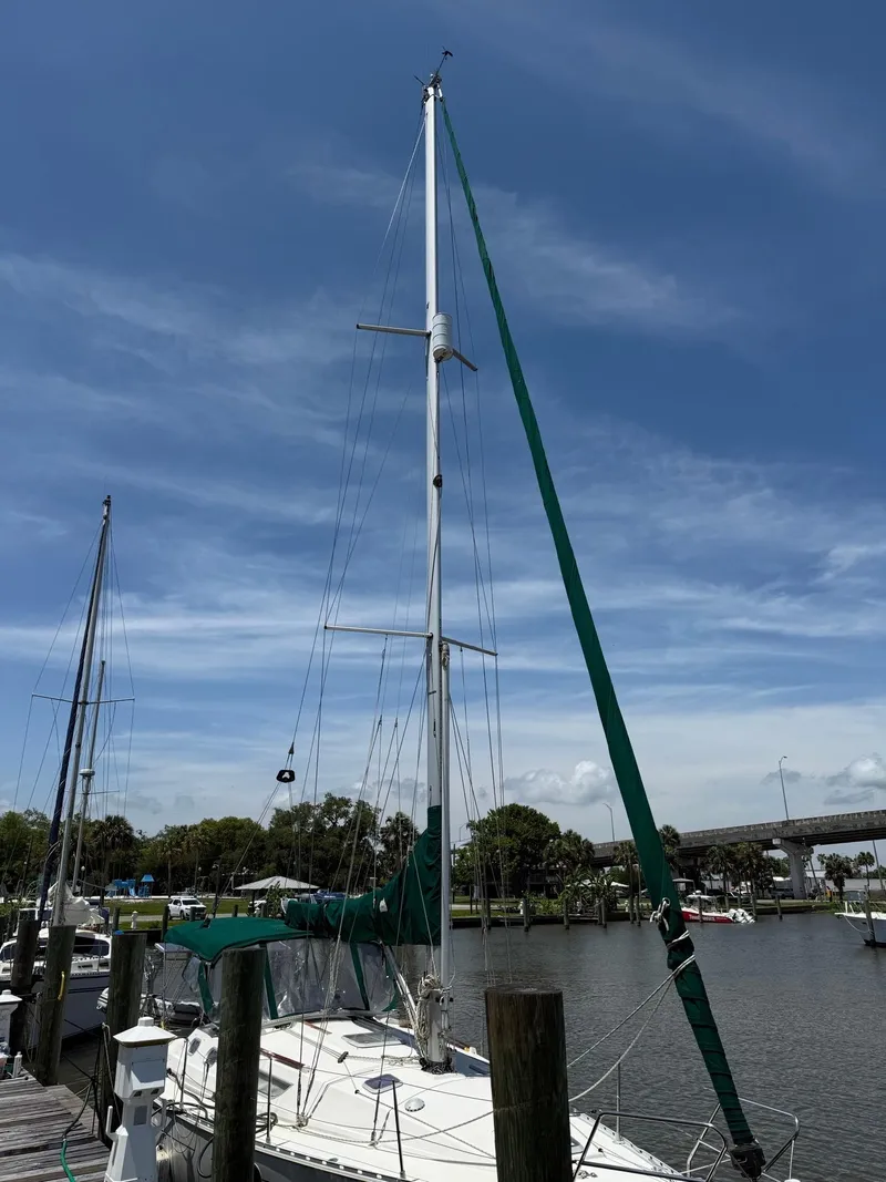 Slide: The Image of 2000 Jeanneau Sun Odyssey 36.2 sailboat docked under clear blue sky. - 5