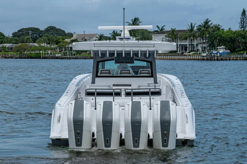 Slide: The Image of 2025 HCB 48 Campeon boat with four powerful outboard engines on the water. - 12