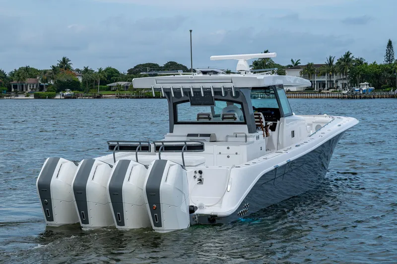 Slide: The Image of 2025 HCB 48 Campeon boat with four engines on a calm waterway. - 13