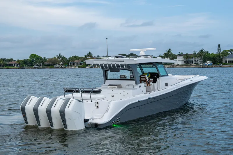 Slide: The Image of 2025 HCB 48 Campeon boat with four engines on a calm waterway. - 14